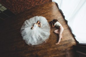 young sexy woman photographer is taking pictures the bride in the studio