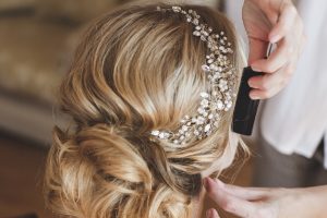 Stylist makes hair the bride