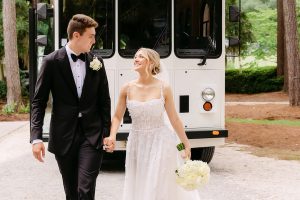 Married couple at their wedding in front of a bus in the lowcountry